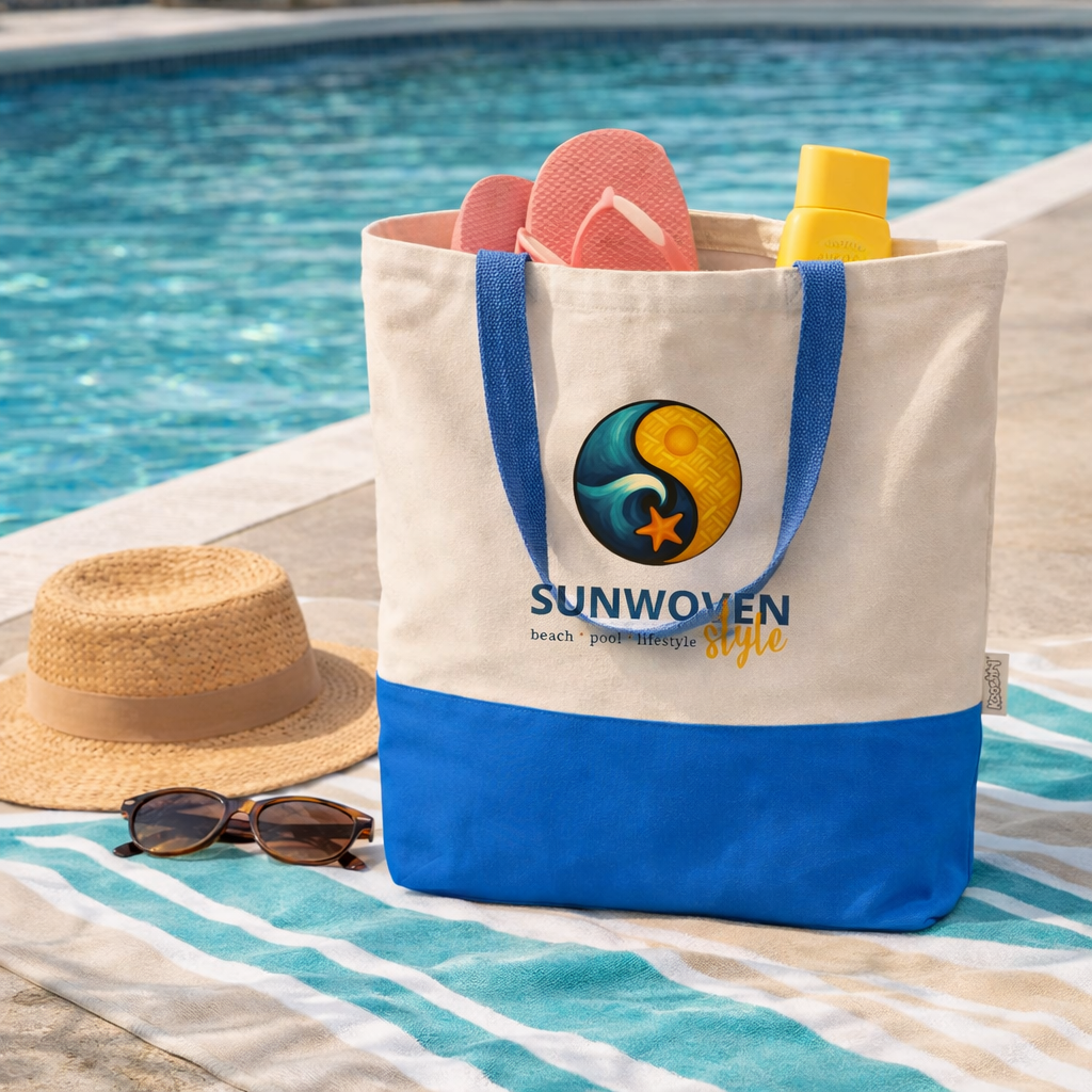 Beach tote bag with 'Sunwoven' logo, sunglasses, hat, and flip-flops by a pool.