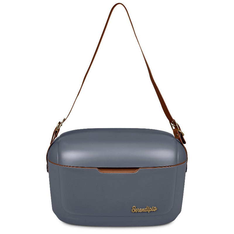 Grey hard plastic cooler box with long tan vegan leather strap on white background