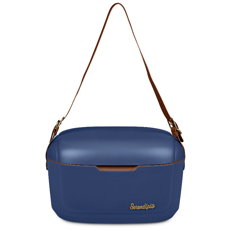 Navy hard plastic cooler box with long tan vegan leather strap on white background