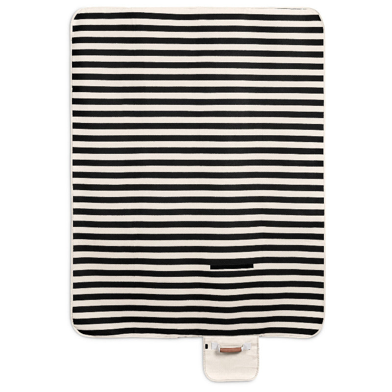 Black and white striped blanket with a closure and handle on a white background