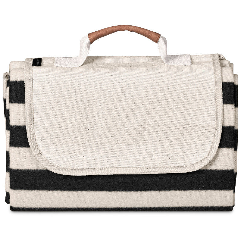 Black and white striped picnic blanket with a handle on a white background
