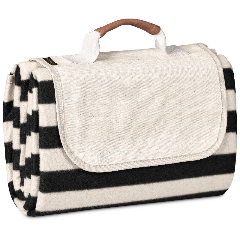 Black and white striped picnic blanket with a handle on a white background