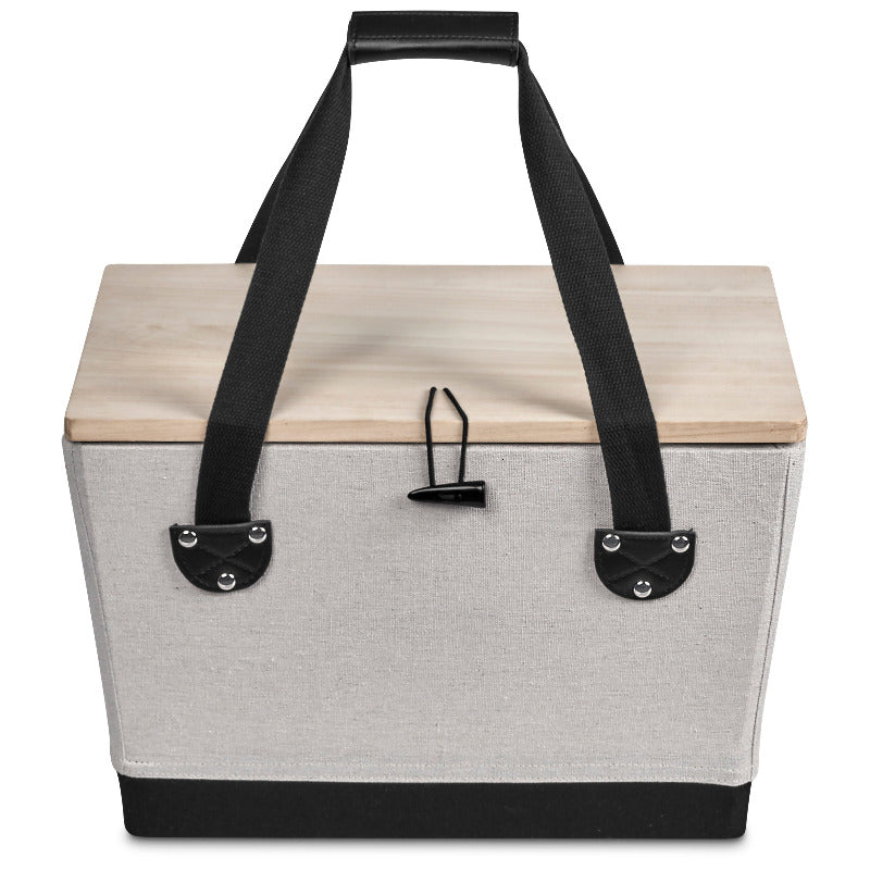 Boxy picnic basket with wooden lid and black handles on white background