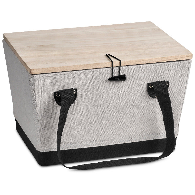 Boxy picnic basket with wooden lid and black handles on white background