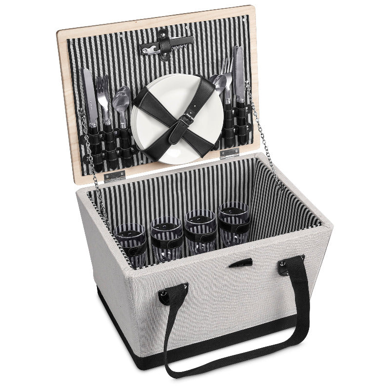 Picnic basket with cutlery, plates, and glasses on a white background