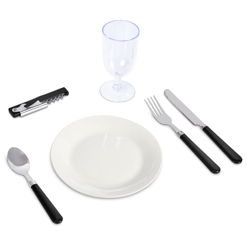 Dinner set with white plate, glass, knife, fork, and spoon on a white background