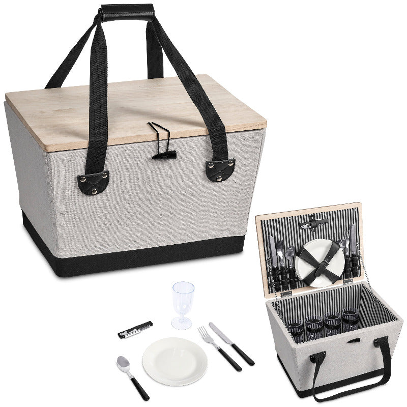 Picnic basket with cutlery and tableware on a white background